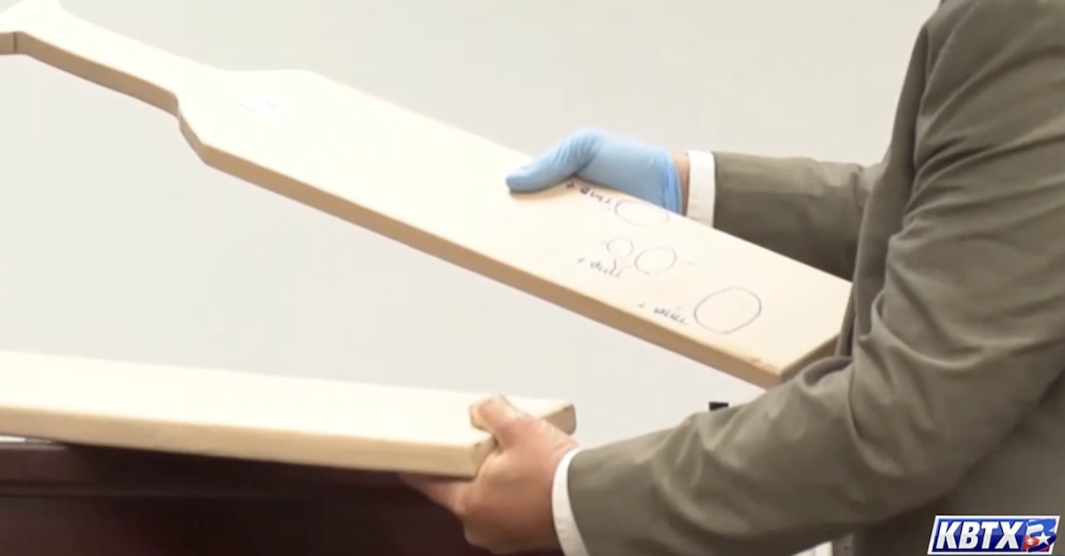 Prosecutors showing the wood paddle Hopper and Bundren used to beat Hopper